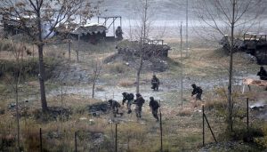 KASHMIR, INDIA - DECEMBER 05: Smoke rises from a bunker as Indian Army soldiers search for suspected militants after an attack on their base at Mohra, in Kashmir, India on December 05, 2014. Militants sneaked into an Indian army camp in Kashmir on Friday morning killing at least ten soldiers and police in their bunkers, the worst losses for security forces in more than a year.  (Photo by Ahmer Khan/Anadolu Agency/Getty Images)