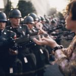 a-17-year-old-girl-offers-a-flower-to-a-soldier-during-the-pentagon-anti-war-protest-in-october-1967