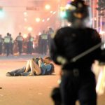 a-couple-kisses-after-the-girl-was-knocked-down-by-a-policeman-during-the-vancouver-riots-which-occurred-after-boston-bruins-win-over-the-vancouver-canucks-in-june-2011