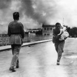 a-journalist-runs-across-a-bridge-to-rescue-a-baby-during-the-civil-war-in-1936