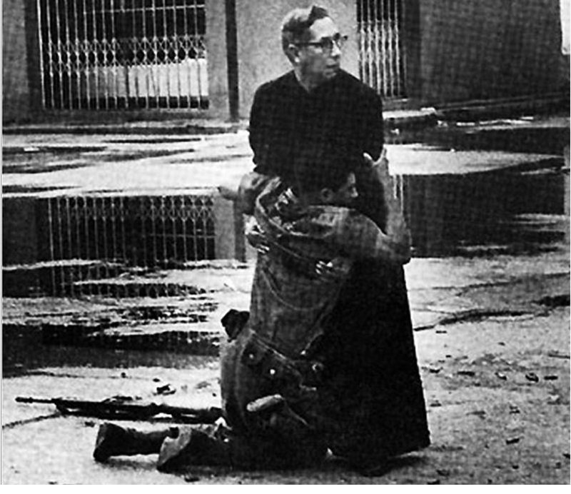 navy-chaplain-luis-padillo-gives-last-rites-to-a-soldier-wounded-by-sniper-fire-during-a-revolt-in-venezuela