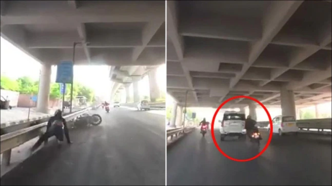 Watch Video SUV Driver Hits Biker on Delhi Road | SUV Driver Hits Biker Viral Video, Delhi Arjan Garh Metro Station Viral Video, Delhi Roadrage Video News in Hindi